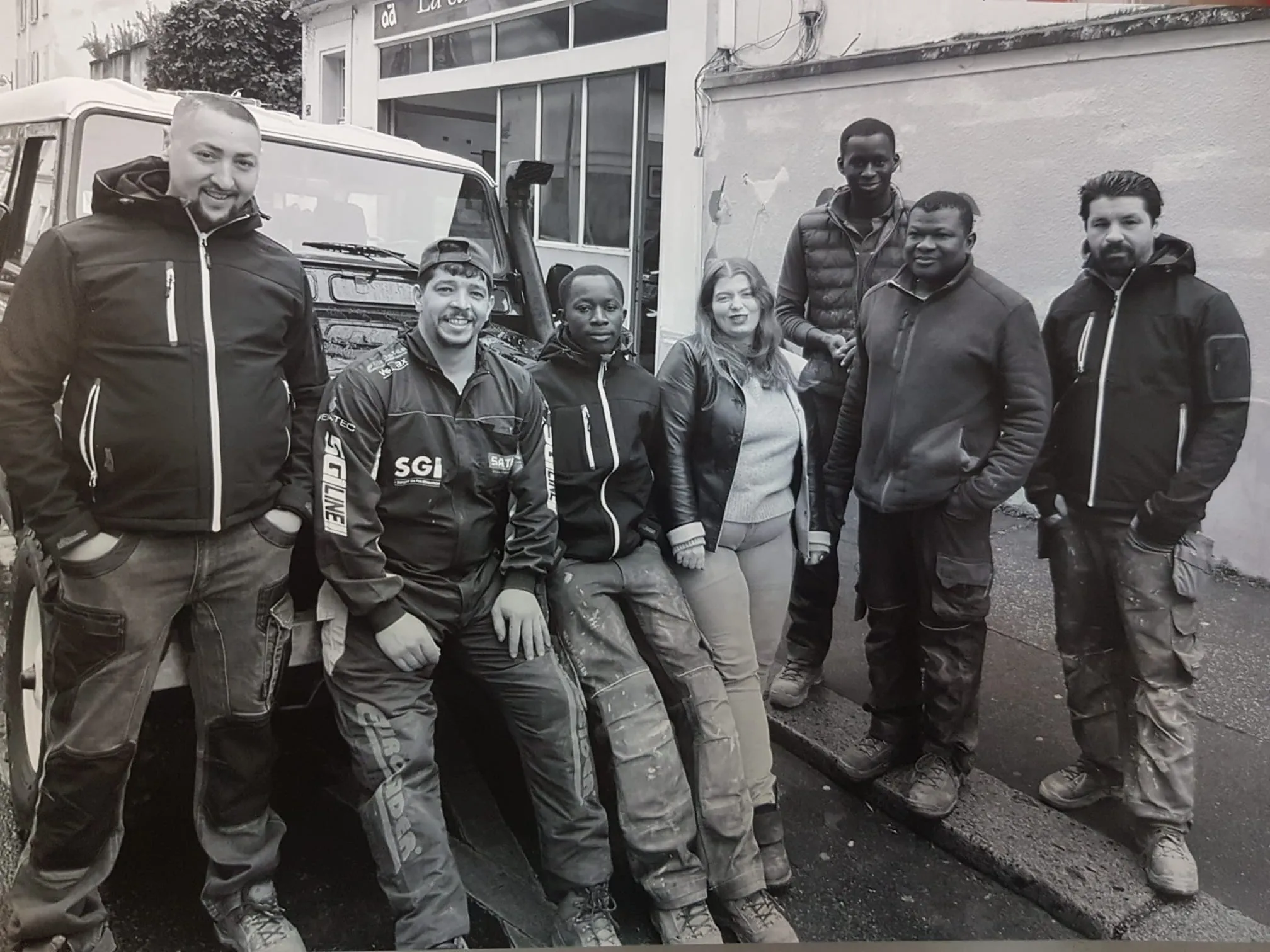 L’équipe de l’atelier pose devant la carrosserie, rue Barrault.